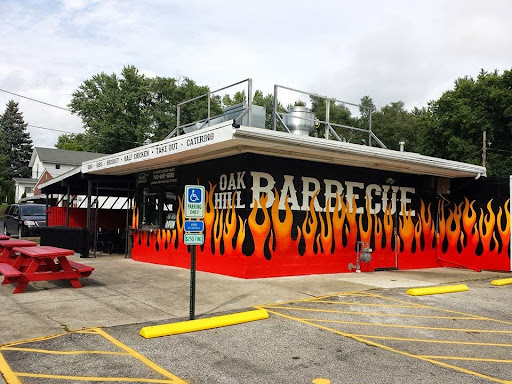 Drain Bros llc offers easy plumbing services near a barbecue restaurant with outdoor seating and parking.