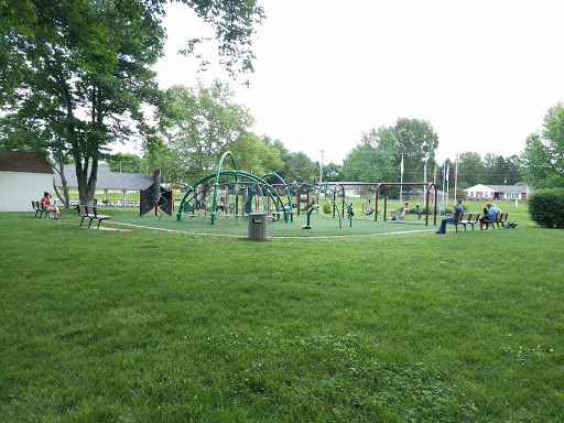 Kids play in a park as Drain Bros llc works on excavation for homes nearby, making the area better for families.