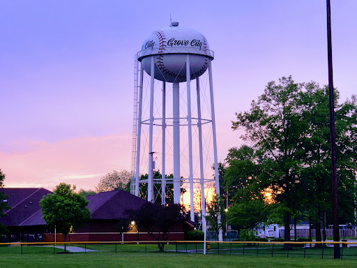 Drain Bros llc helps Grove City with plumbing and excavation, shown by a tall baseball water tower for the community.