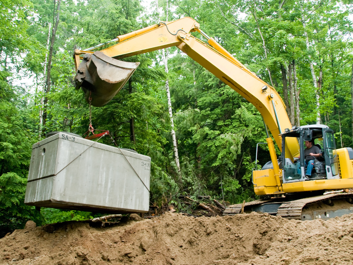 Drain Bros llc helps install septic systems, using heavy equipment for safe digging and concrete placement in homes.