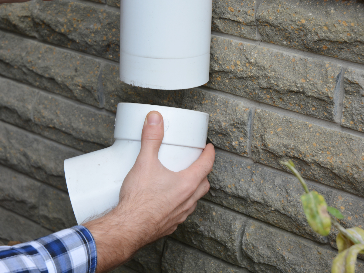 Drain Bros llc shows a worker fixing sewer problems by repairing pipes, helping keep homes safe from drain issues.