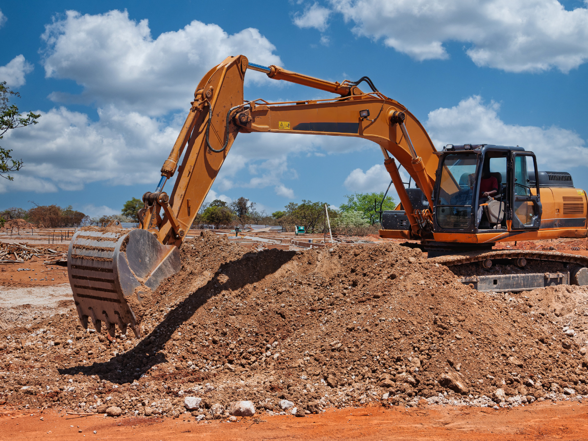 Drain Bros llc prepares land for new drainage installation, showing teamwork and project progress at a busy construction site.