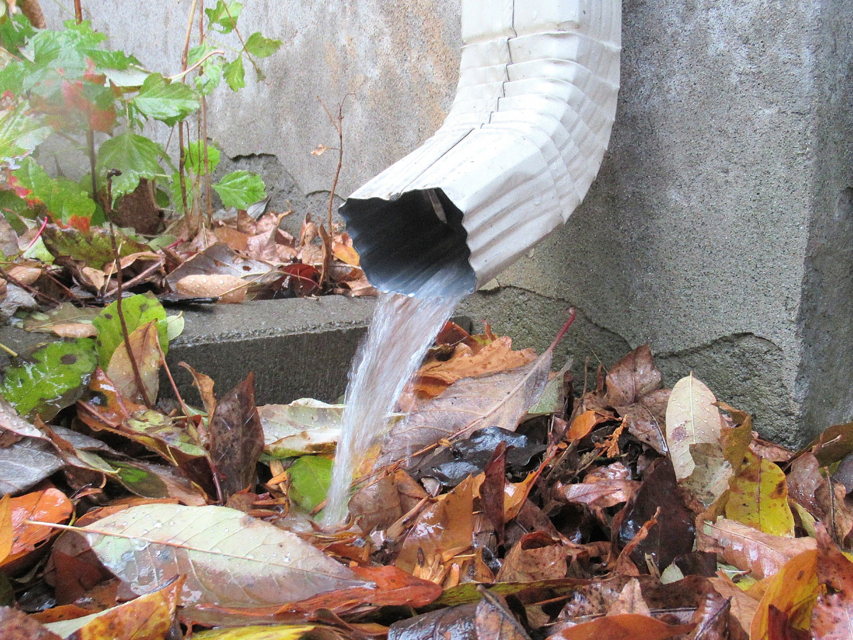 Drain Bros llc shows how their gutter system keeps homes safe by moving rainwater away from the house toward the ground.